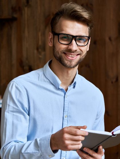 Homepage 13 smiling young business man holding planner looking 2022 02 05 07 34 47 utc 1